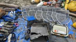 collection of plastic debris laid out on a tarp