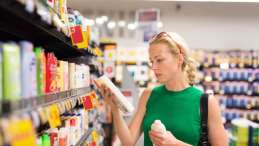 photo of a women shopping in a store with shelves of product