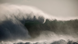 huge crashing wave in dark stormy sea with title Coastal First Nations call on Carney to defend the B.C. tanker ban in pipeline talks