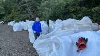 Gigantic collection bags line the beach filled with plastic marine debris