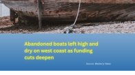 abandoned boat image on beach with title below Abandoned boats left high and dry on west coast as funding cuts deepen