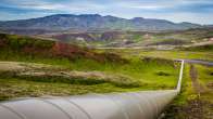 photo of pipeline laid across vast mountainous area. Photo credit Mike Benna
